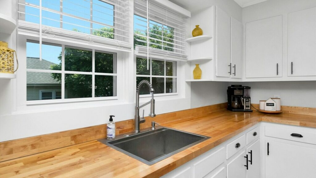 a kitchen with white cabinets and a sink